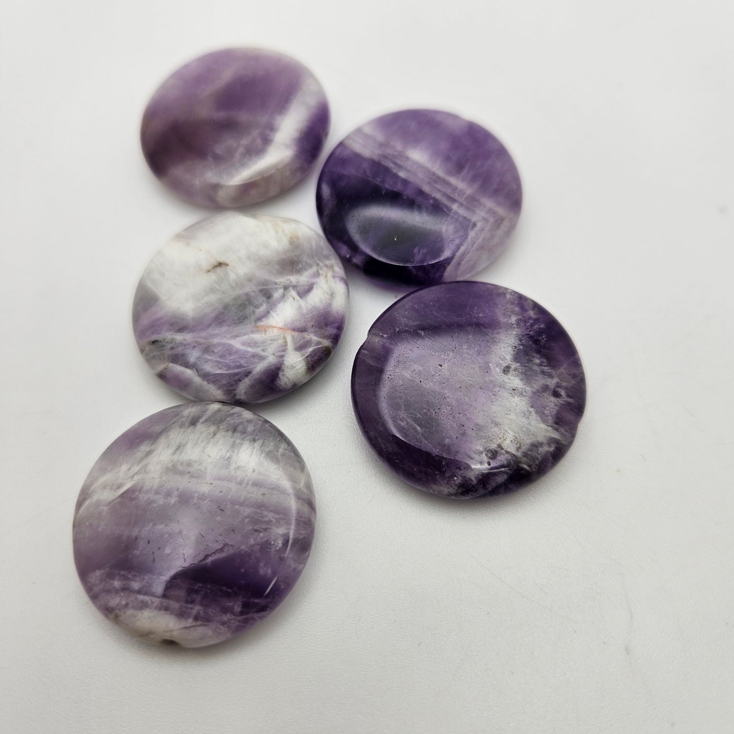 20mm Amethyst Coin SINGLE stones with varying shades of purple and white marbling.