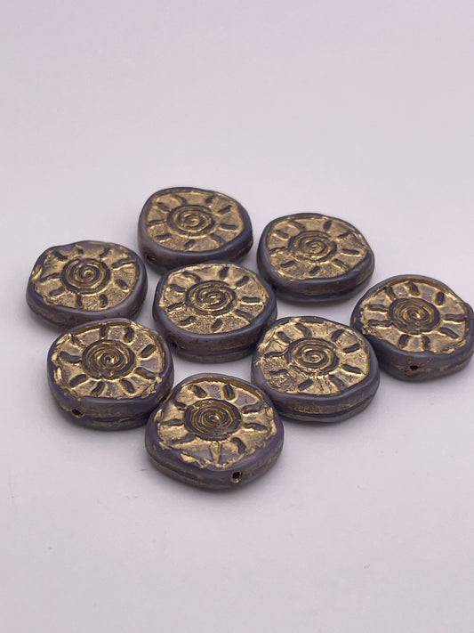 Eight 15mm beads, named the Purple Spiral Sun Czech Single Bead, are artistically arranged on a plain white background. These round beads feature metallic gold floral designs and showcase a glossy finish with a captivating dark, textured surface.